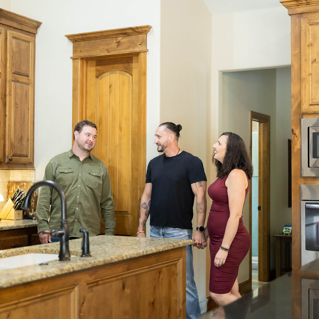Real estate agent showing a home to prospective buyers to help sell your home.