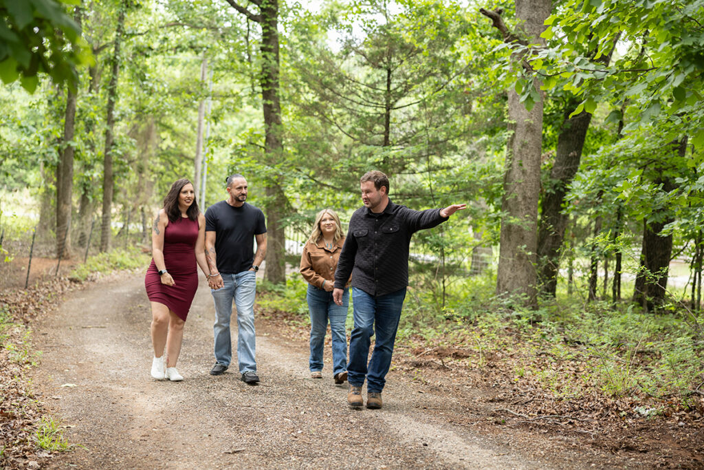 Hagan Home Team walking with clients during a property tour and discussing the home's features.