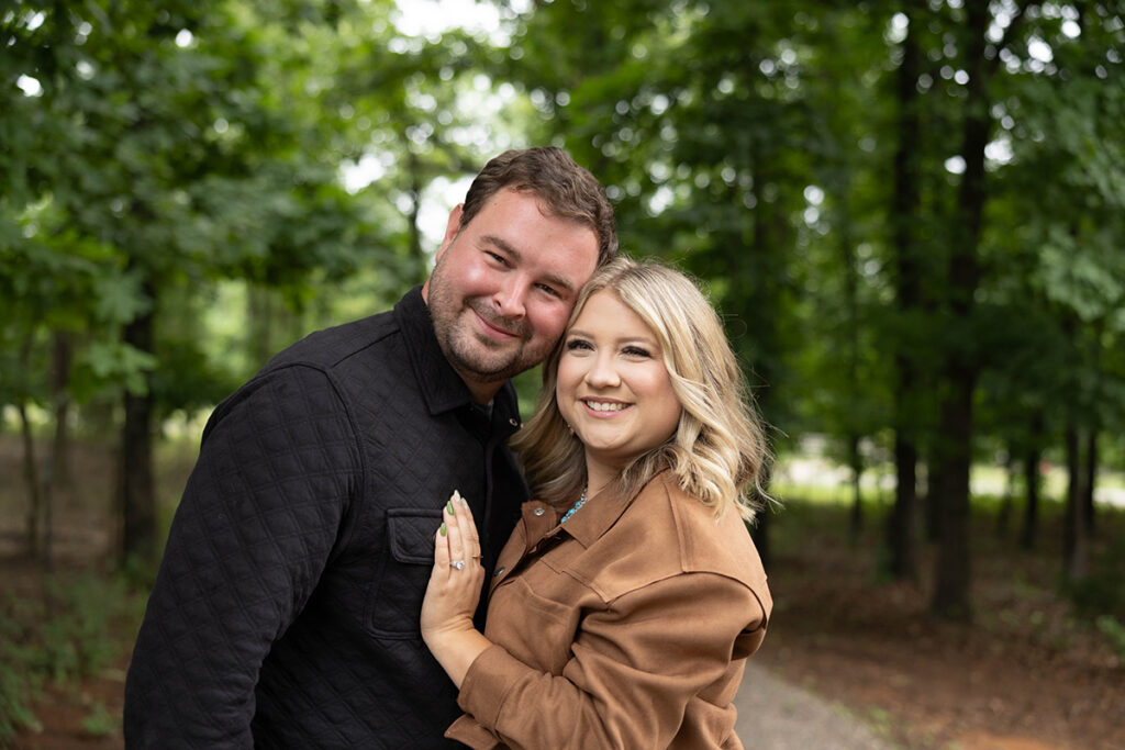 Jon and Logan Hagan smiling together during an outdoor Hagan Home Team portrait.